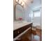 Bathroom featuring a modern vanity and a shower-tub combo, offering style and functionality at 1219 E Seldon Ln, Phoenix, AZ 85020