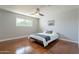 Bright bedroom featuring a modern ceiling fan and a window showcasing a lush, green outdoor view at 1219 E Seldon Ln, Phoenix, AZ 85020