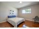 This airy bedroom features a large window and polished concrete floors for a clean, modern look at 1219 E Seldon Ln, Phoenix, AZ 85020