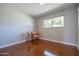 Sunlit bedroom with polished concrete floors and a cozy sitting area by the window at 1219 E Seldon Ln, Phoenix, AZ 85020