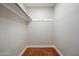 A simple closet with a hanging rod and polished concrete floor for streamlined storage at 1219 E Seldon Ln, Phoenix, AZ 85020