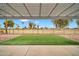 Covered patio overlooks a putting green and mature trees at 12451 N Cherry Hills E Dr, Sun City, AZ 85351