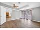 Bright bedroom with wood-look floors and patio access at 12451 N Cherry Hills E Dr, Sun City, AZ 85351