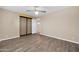 Simple bedroom with wood-look floors and ceiling fan at 12451 N Cherry Hills E Dr, Sun City, AZ 85351