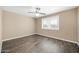 Bedroom with wood-look floors and window with blinds at 12451 N Cherry Hills E Dr, Sun City, AZ 85351