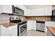 Stainless steel appliances and wood countertops highlight this kitchen at 12451 N Cherry Hills E Dr, Sun City, AZ 85351