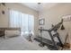 Bright bedroom with a treadmill and window coverings at 1255 N Arizona Ave # 1109, Chandler, AZ 85225