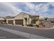 Tan two-car garage home with brown doors and landscaping at 1255 N Arizona Ave # 1109, Chandler, AZ 85225