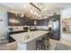 Granite kitchen island with stainless steel sink and breakfast bar at 1255 N Arizona Ave # 1109, Chandler, AZ 85225