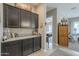 Dark brown cabinets and granite countertop in kitchen at 1255 N Arizona Ave # 1109, Chandler, AZ 85225