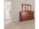 Bedroom with dresser and mirror, offering views into hallway at 14250 W Wigwam Blvd # 2121, Litchfield Park, AZ 85340