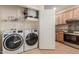 Convenient laundry room with washer, dryer, and storage at 14250 W Wigwam Blvd # 2121, Litchfield Park, AZ 85340