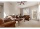 Living room featuring brown couches and a coffee table at 14250 W Wigwam Blvd # 2121, Litchfield Park, AZ 85340