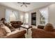 Bright living room with brown couches and a coffee table at 14250 W Wigwam Blvd # 2121, Litchfield Park, AZ 85340