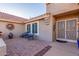 Courtyard entry with brick pavers, wrought iron gate, and seating area at 14316 W Circle Ridge Dr, Sun City West, AZ 85375