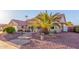 Landscaped front yard with a circular walkway and a large palm tree at 14316 W Circle Ridge Dr, Sun City West, AZ 85375