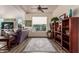 Living room with hardwood floors, a large window, and a wood bookcase at 14316 W Circle Ridge Dr, Sun City West, AZ 85375