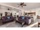 Living room with hardwood floors, two sofas, and a view into kitchen at 14316 W Circle Ridge Dr, Sun City West, AZ 85375