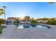 Irregular shaped pool with a water feature and surrounding landscaping at 14316 W Circle Ridge Dr, Sun City West, AZ 85375