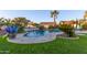 Freeform pool with a stone deck and a blue glass sculpture at 14316 W Circle Ridge Dr, Sun City West, AZ 85375