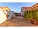 Landscaped side yard with a gate and decorative wall art at 14316 W Circle Ridge Dr, Sun City West, AZ 85375