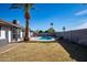 Spacious backyard with pool, grass, and a palm tree at 1437 W Ross Ave, Phoenix, AZ 85027