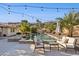 Inviting backyard oasis featuring a sparkling pool, patio furniture, and string lights at 15212 N Palmetto Ln, Fountain Hills, AZ 85268