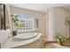 Spa-like bathroom with soaking tub, walk-in shower, and glass block window at 15212 N Palmetto Ln, Fountain Hills, AZ 85268