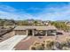 Single story home with a two car garage and mountain views in the background at 15212 N Palmetto Ln, Fountain Hills, AZ 85268