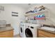 Convenient laundry room with washer, dryer, and shelving at 15212 N Palmetto Ln, Fountain Hills, AZ 85268