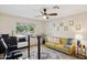 Home office with standing desk, yellow couch, and ceiling fan at 15212 N Palmetto Ln, Fountain Hills, AZ 85268