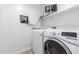 Laundry room with washer, dryer, and shelving for storage at 1529 S 357Th Ave, Tonopah, AZ 85354