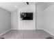 Living room with gray walls, wood-look floors, and a mounted TV at 1529 S 357Th Ave, Tonopah, AZ 85354