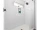 Clean shower with white tile and small window at 1529 S 357Th Ave, Tonopah, AZ 85354