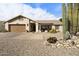 Single-story home with a two-car garage and desert landscaping at 1532 Leisure World --, Mesa, AZ 85206