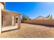 Large backyard with gravel and covered patio at 15365 W Caribbean Ln, Surprise, AZ 85379