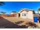 View of backyard, house exterior, and blue bin at 15365 W Caribbean Ln, Surprise, AZ 85379