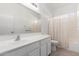 Well-lit bathroom with bathtub and white vanity at 15365 W Caribbean Ln, Surprise, AZ 85379