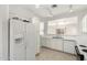 Kitchen with white cabinets, stainless steel sink, and appliances at 15365 W Caribbean Ln, Surprise, AZ 85379