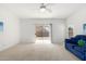 Living room featuring a blue couch and sliding glass doors at 15365 W Caribbean Ln, Surprise, AZ 85379