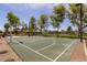 Community basketball court with lush landscaping, park benches, and mature trees at 163 W Dragon Tree Ave, Queen Creek, AZ 85140