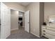 Carpeted bedroom featuring a neutral palette with a open doorway to a living area at 163 W Dragon Tree Ave, Queen Creek, AZ 85140