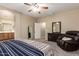 Well-lit bedroom featuring a reading chair, a dresser, and a connected bathroom at 163 W Dragon Tree Ave, Queen Creek, AZ 85140