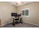 Study room with carpet, ceiling fan, window and wooden table with two monitors at 163 W Dragon Tree Ave, Queen Creek, AZ 85140