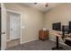 View of the room featuring a table with two monitors, carpet, a door and a closet at 163 W Dragon Tree Ave, Queen Creek, AZ 85140