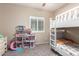 Shared bedroom features a bunk bed and closet and window at 163 W Dragon Tree Ave, Queen Creek, AZ 85140