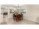 The dining area features a wood table and seating for six as well as views into the living area at 163 W Dragon Tree Ave, Queen Creek, AZ 85140