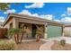 One-story home with green garage door and landscaped front yard at 163 W Dragon Tree Ave, Queen Creek, AZ 85140