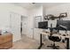 Spacious home office with two computer monitors and built-in shelving at 163 W Dragon Tree Ave, Queen Creek, AZ 85140