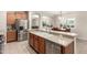The kitchen has stainless appliances and wood cabinets, as well as a double sink and breakfast bar at 163 W Dragon Tree Ave, Queen Creek, AZ 85140